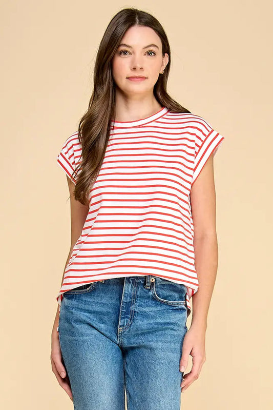 Woman wearing a red and white striped shirt and blue jeans on a beige background