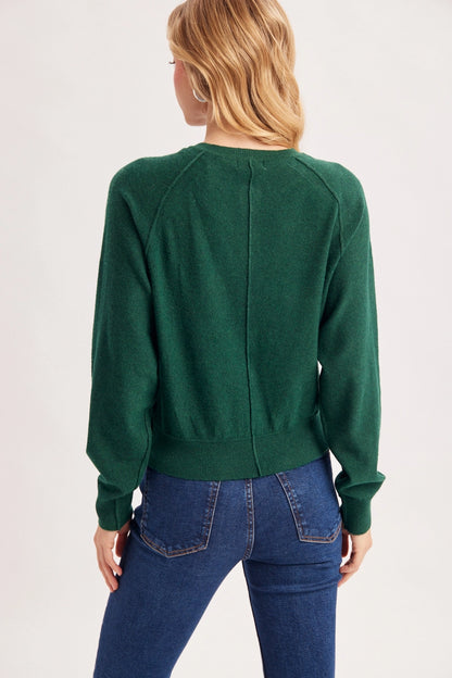 back view of woman in sweater and jeans
