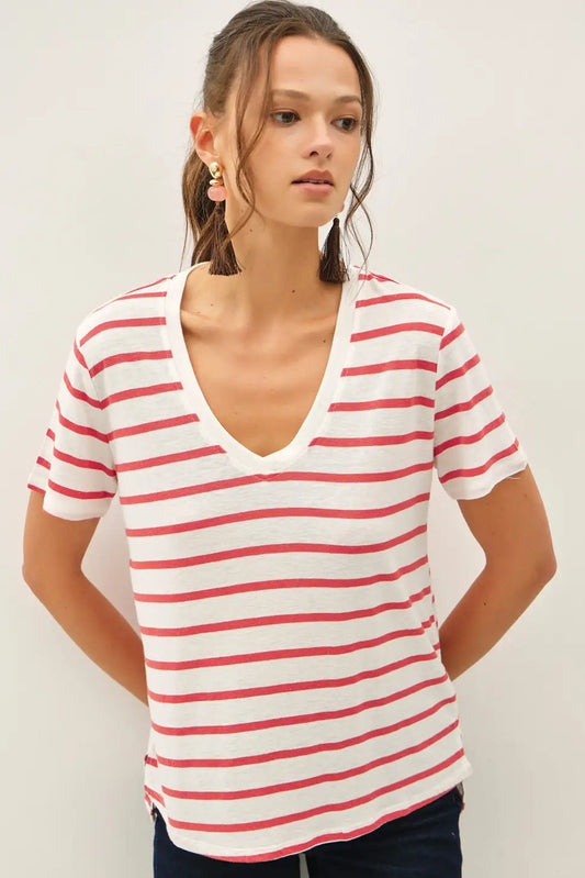 Woman wearing a red and white striped shirt against a plain background