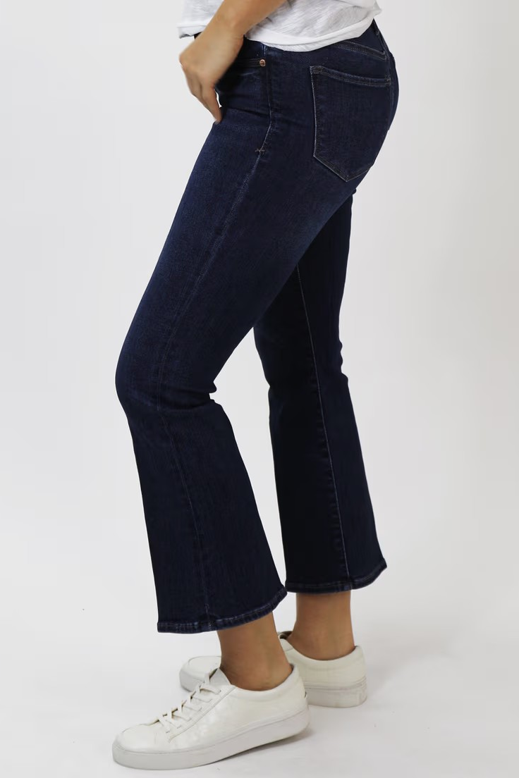 person wearing dark wash jeans