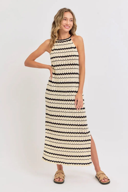 Woman wearing a black and white striped dress on a white background