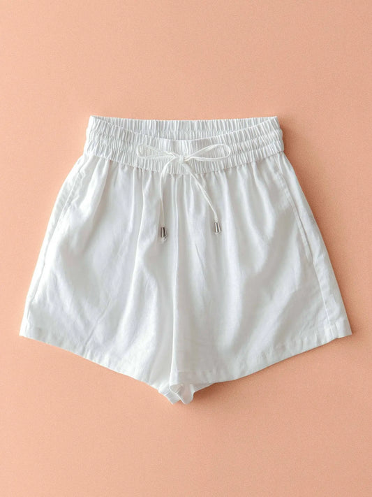 White shorts on a peach background