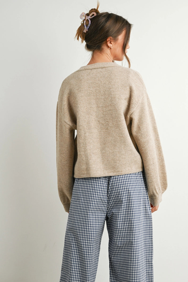back view of woman in cardi and checkered pants