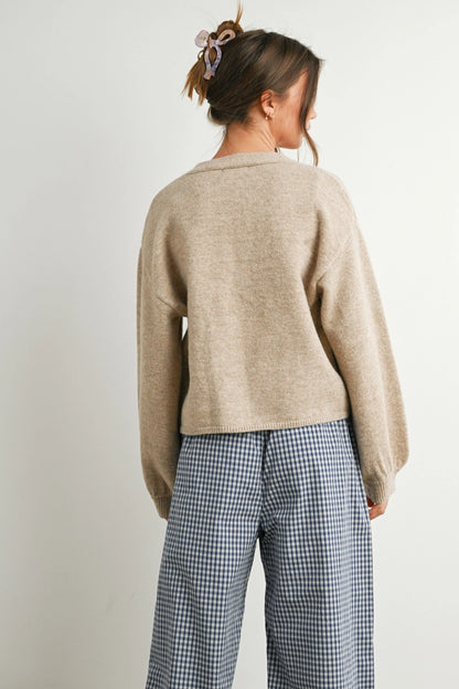 back view of woman in cardi and checkered pants