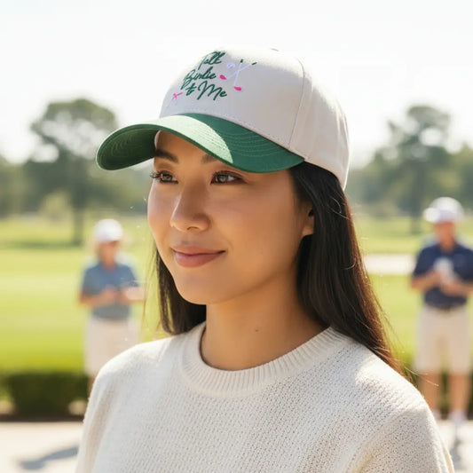 Woman wearing a cap with text on a golf course