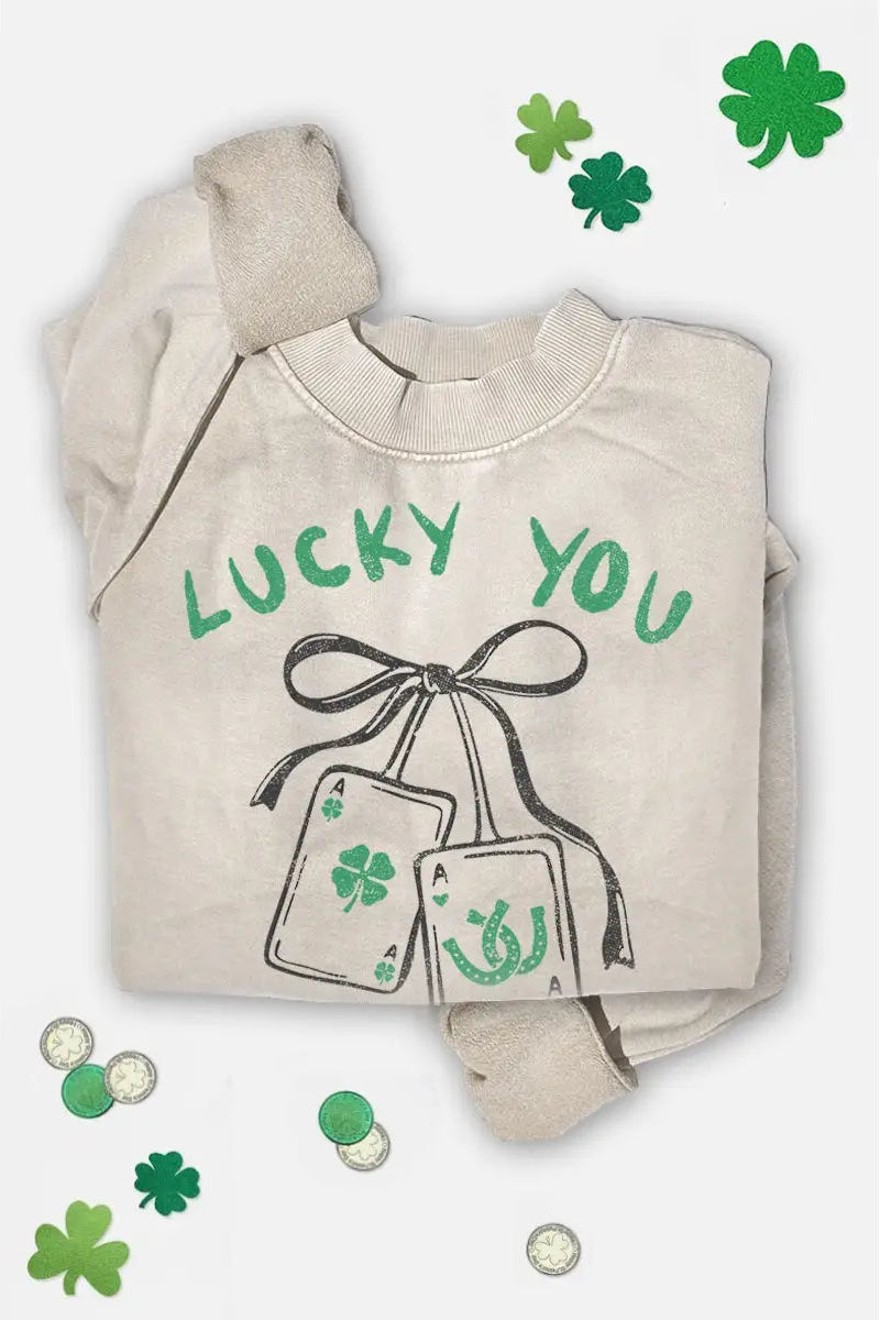 Beige sweatshirt with 'Lucky You' text and shamrock design on a white background