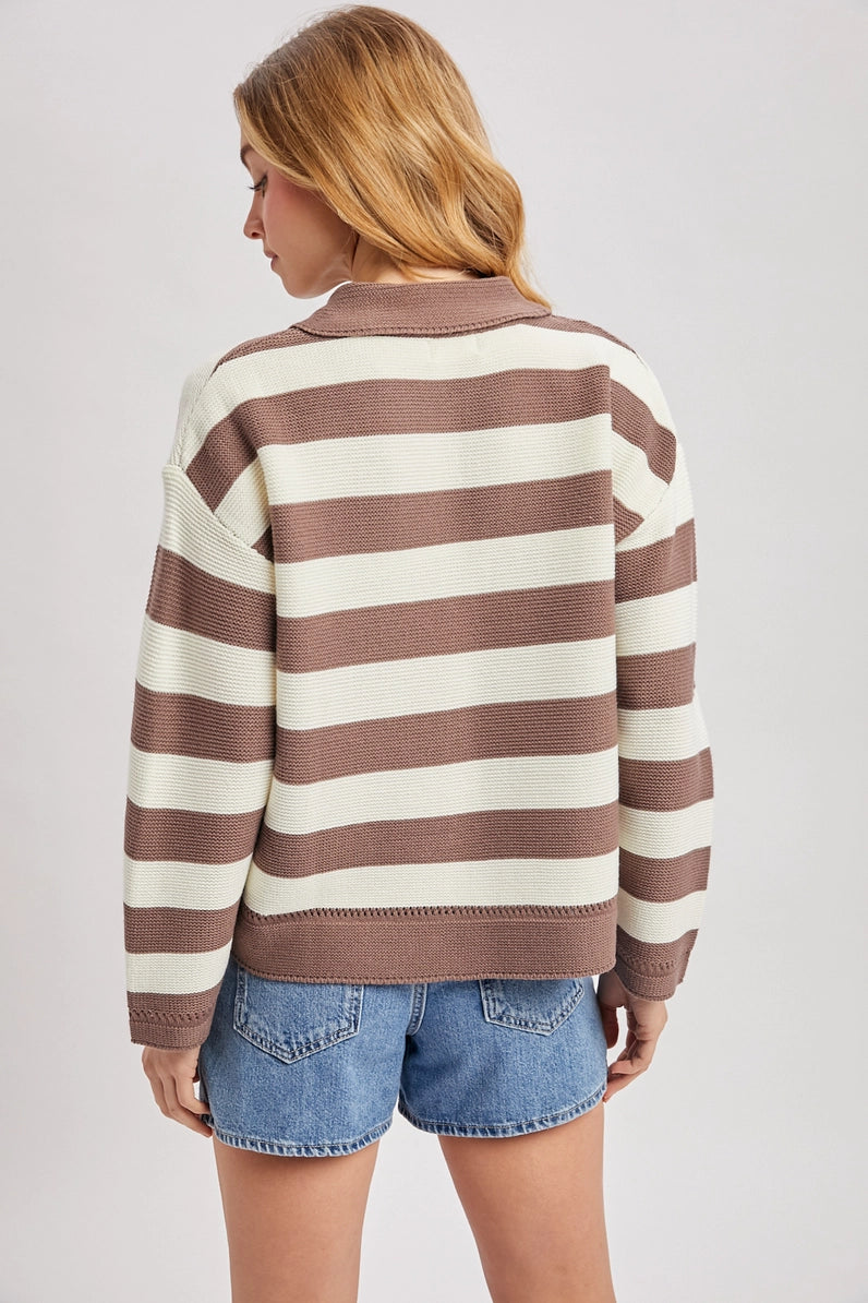 back view of woman in striped sweater and shorts