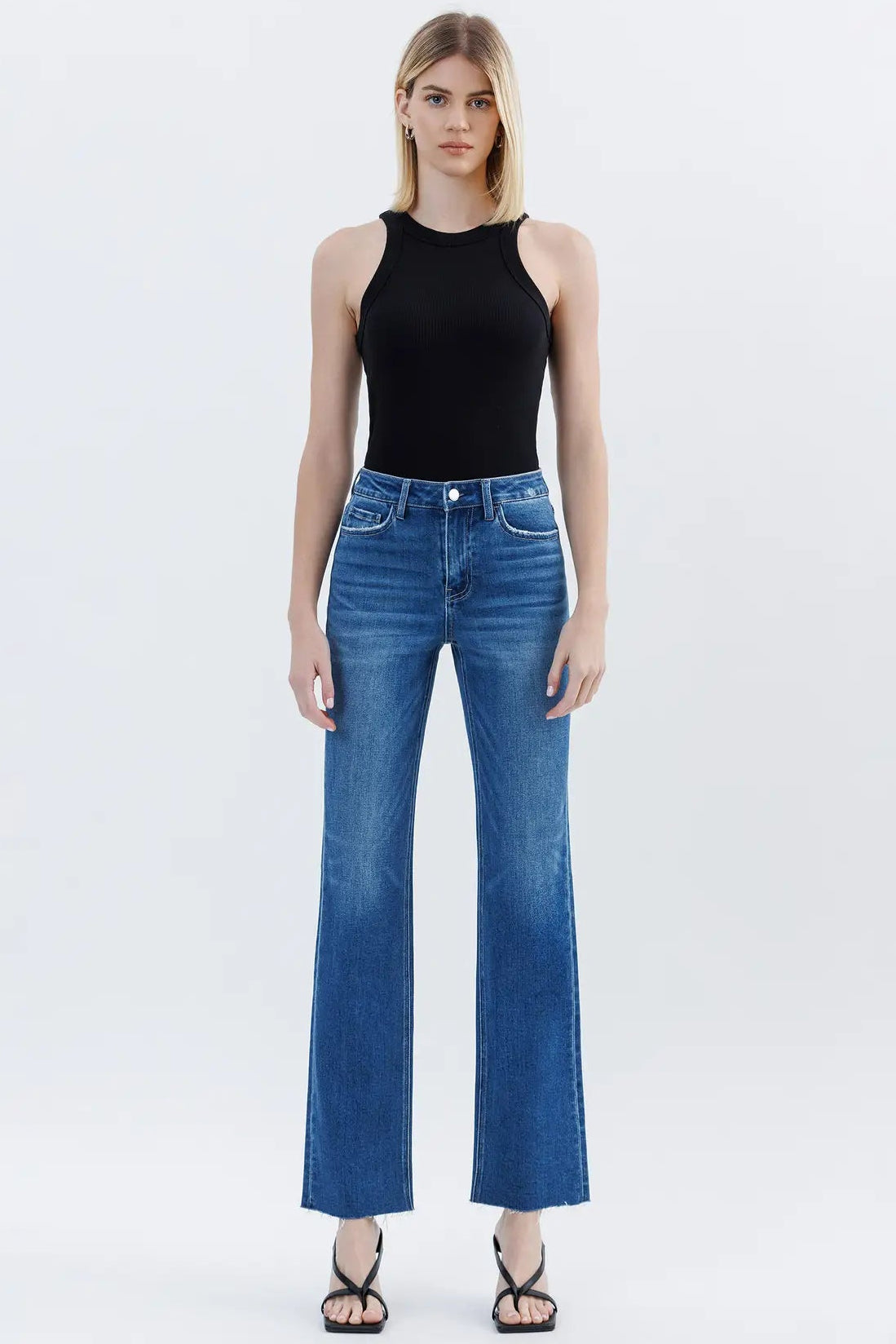 woman in black tank and medium wash denim