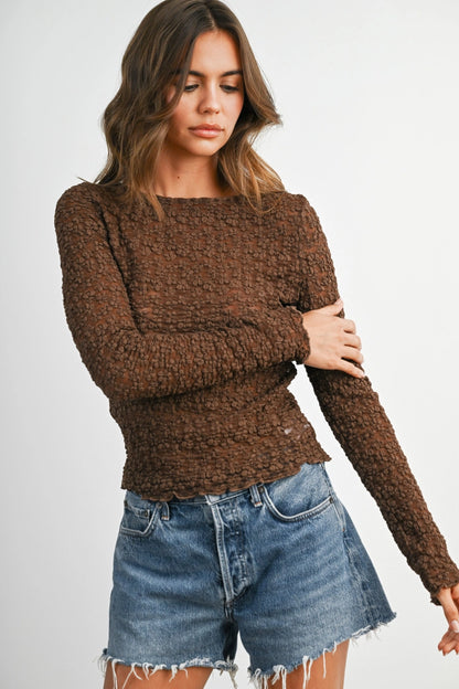 woman in textured long sleeve shirt and shorts