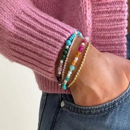 person wearing colorful bracelets