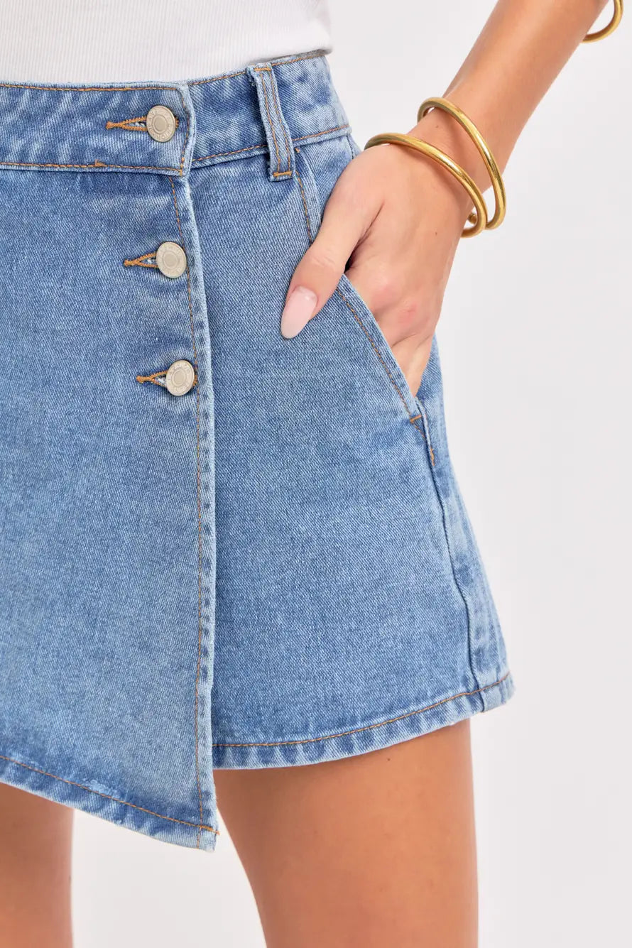 Denim skirt with button details on a plain background