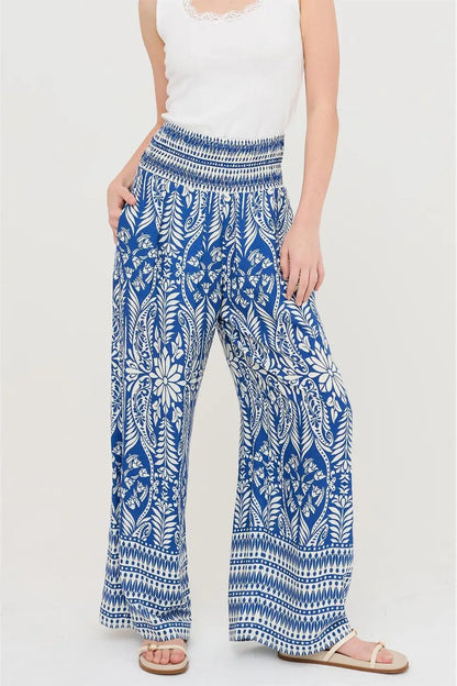 Woman wearing blue and white patterned pants on a white background