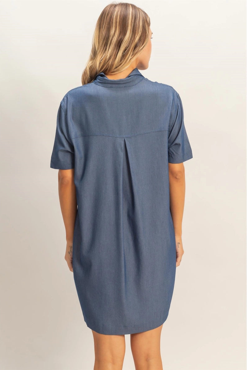 Woman wearing a blue dress against a plain background