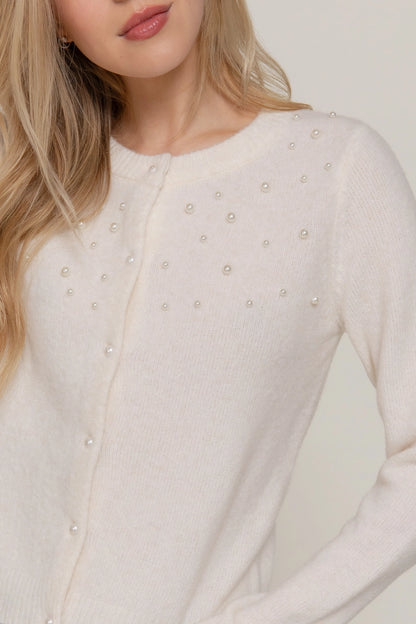 woman in pearl cardigan 