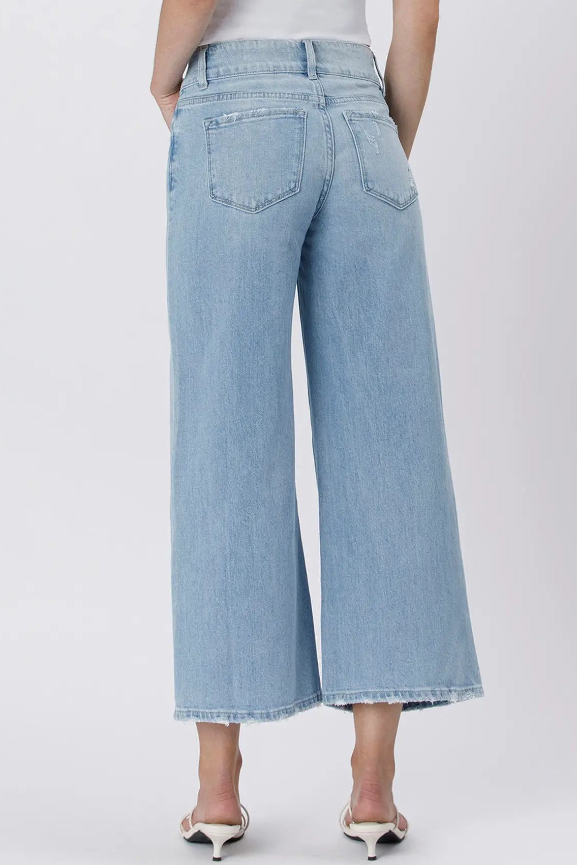 Light blue wide-leg jeans worn by a person on a white background