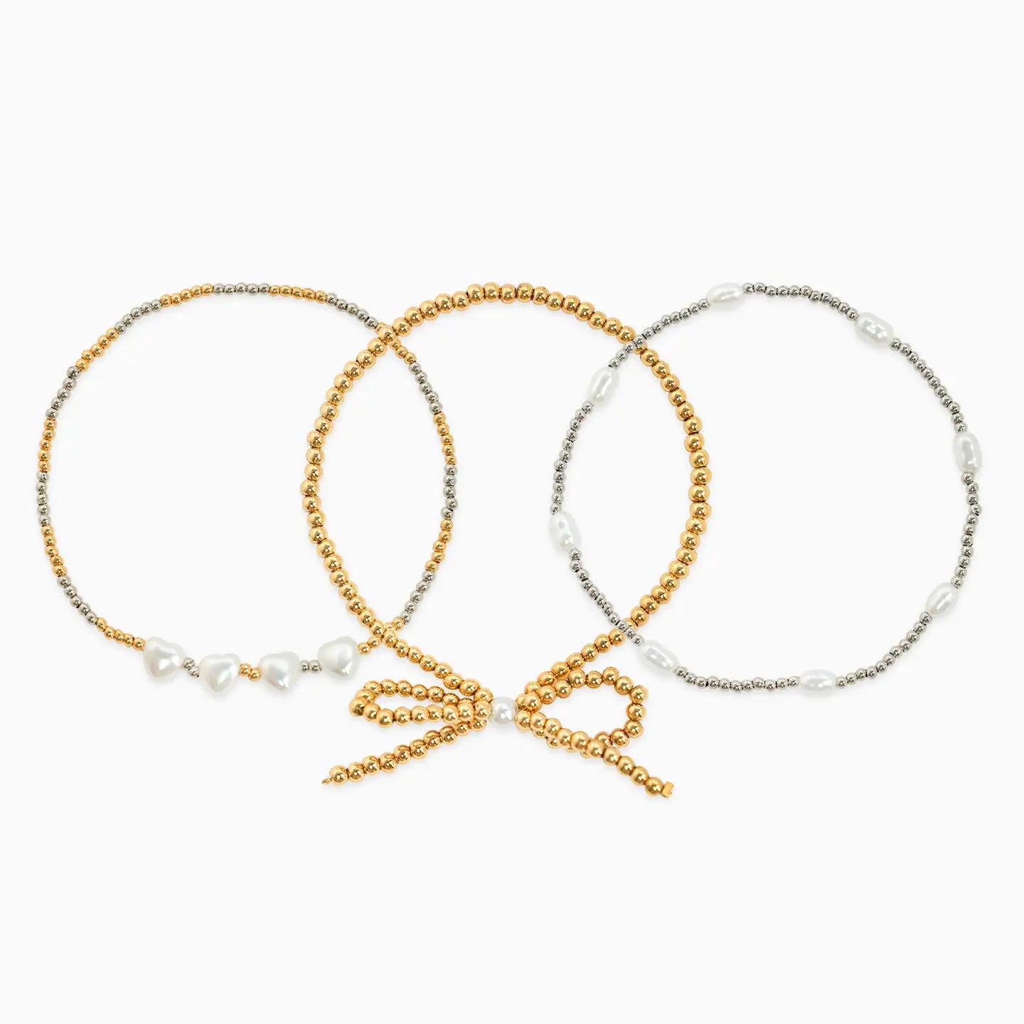 Three beaded hair ties in gold, silver, and a mix of both on a white background.