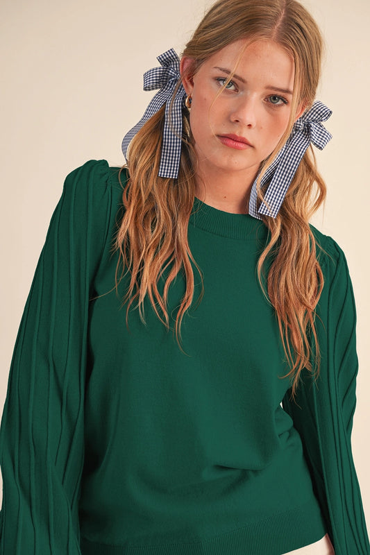 girl in green pleated sleeve sweater