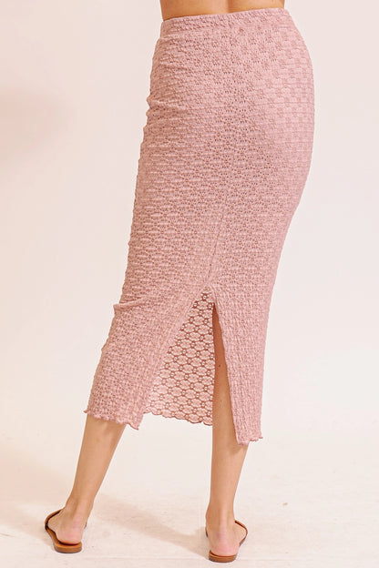 Pink textured skirt worn by a person on a beige background