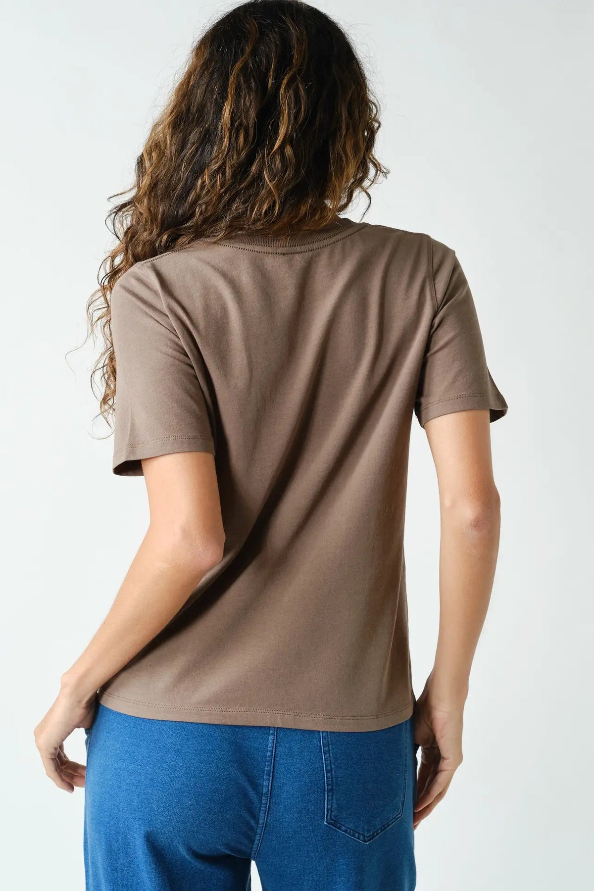 back view of woman in tee and jeans