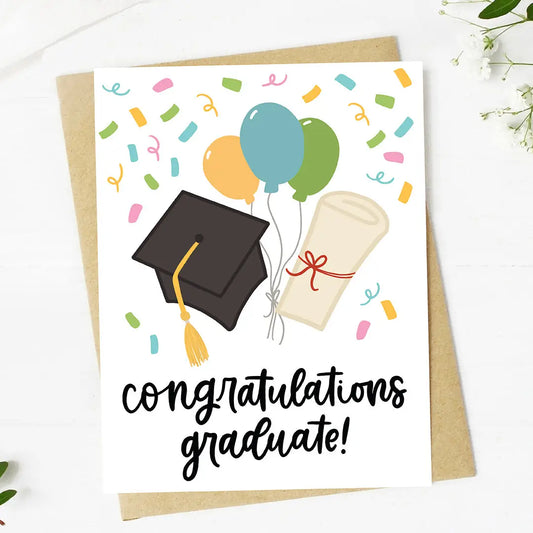 Graduation-themed card with balloons, mortarboard, diploma, and 'Congratulations Graduate!' text on a white background.