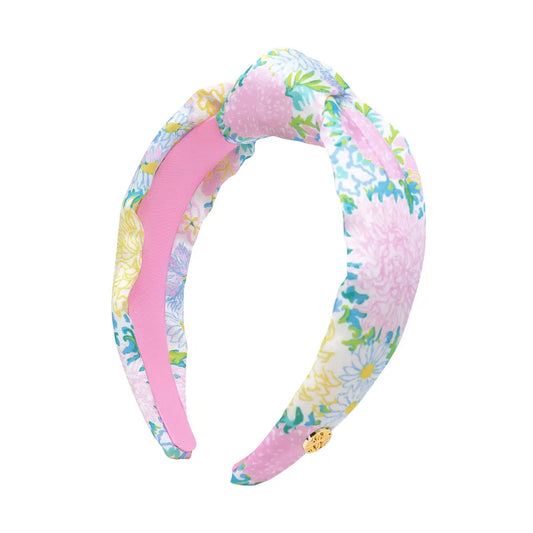 Floral patterned headband with pink center on a white background