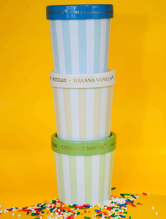 Stack of paper cups with colorful labels on a yellow background