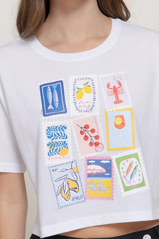 White t-shirt with colorful graphic designs on a plain background