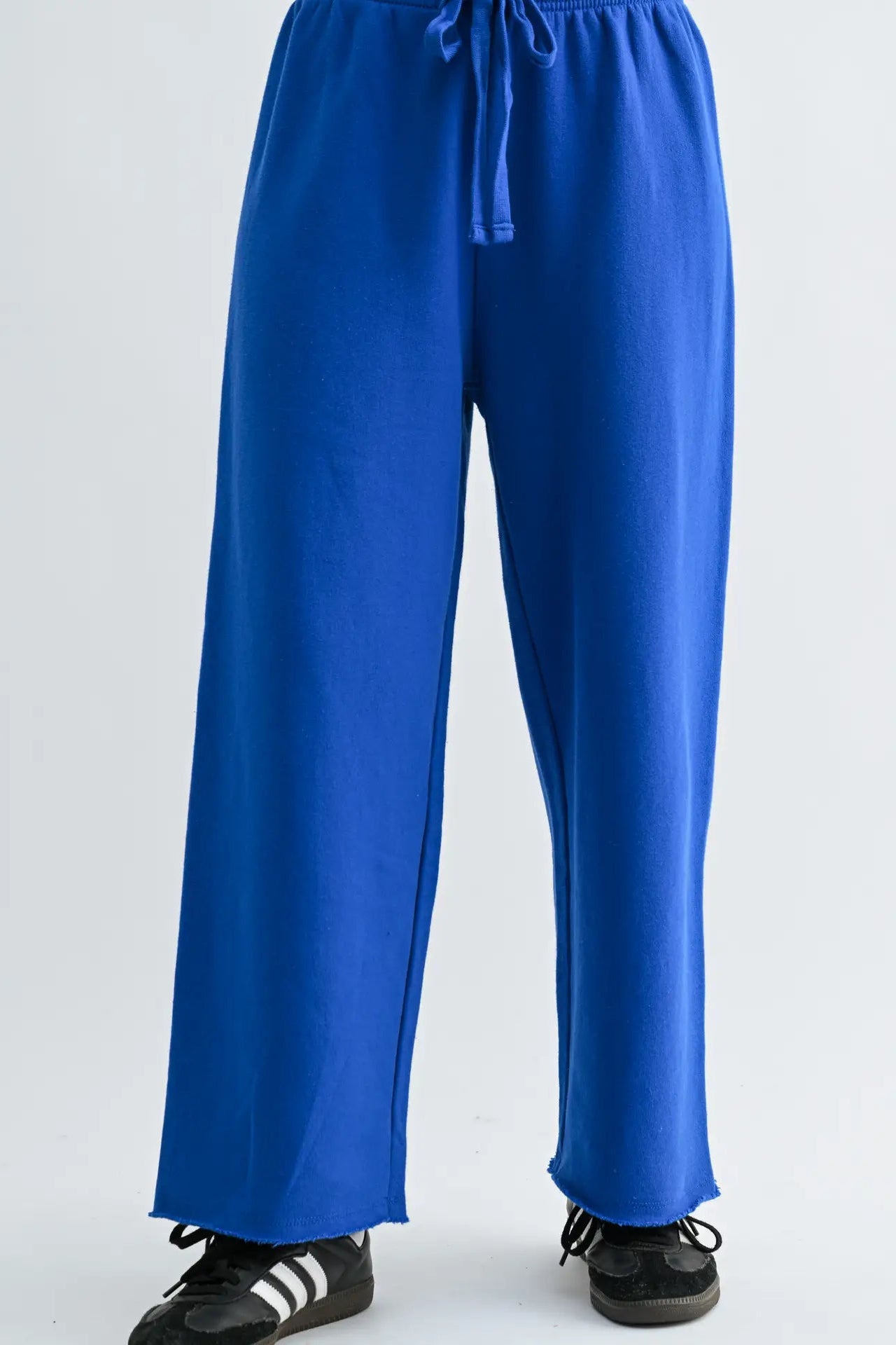 Blue pants worn by a person on a white background