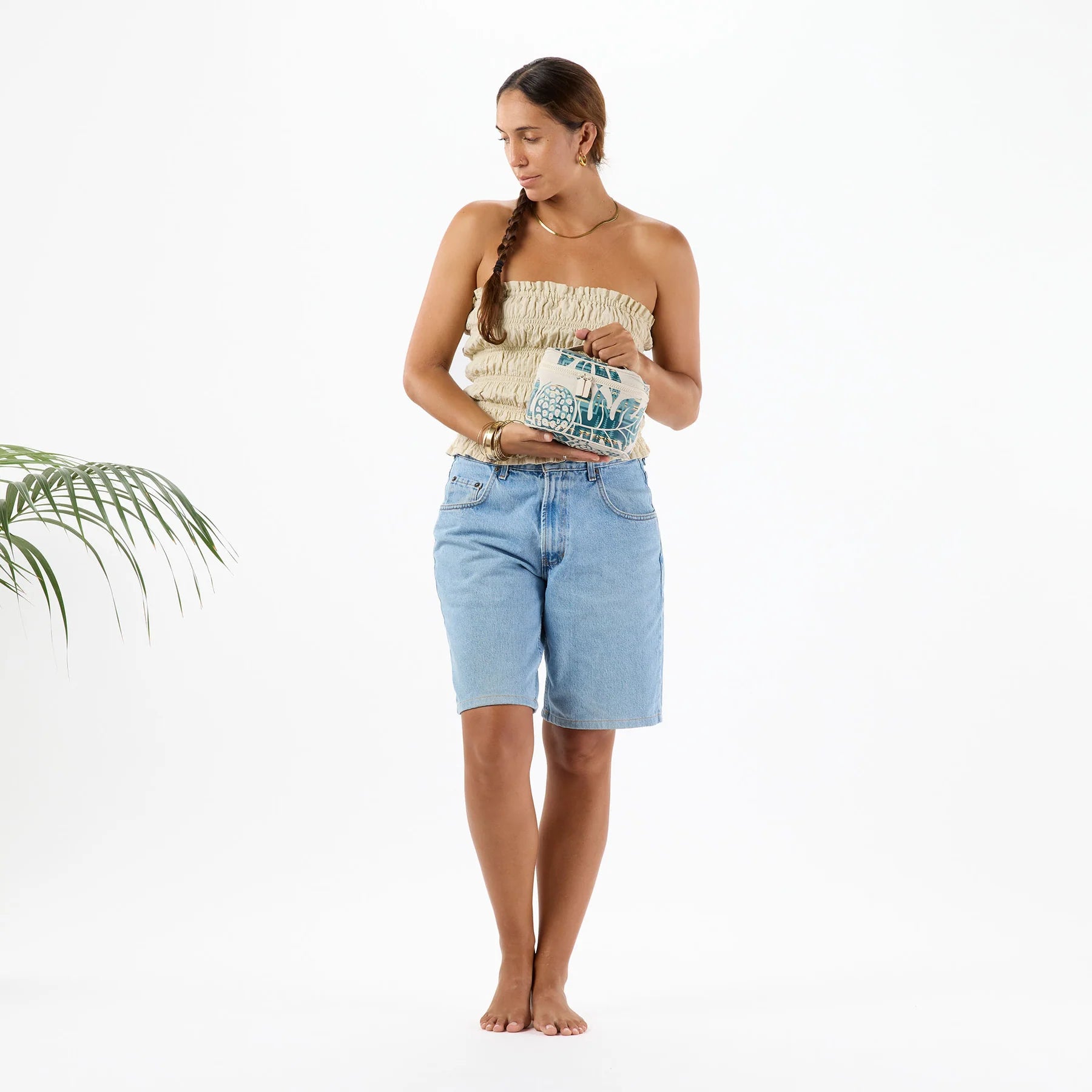 Woman holding a patterned bag against a white background