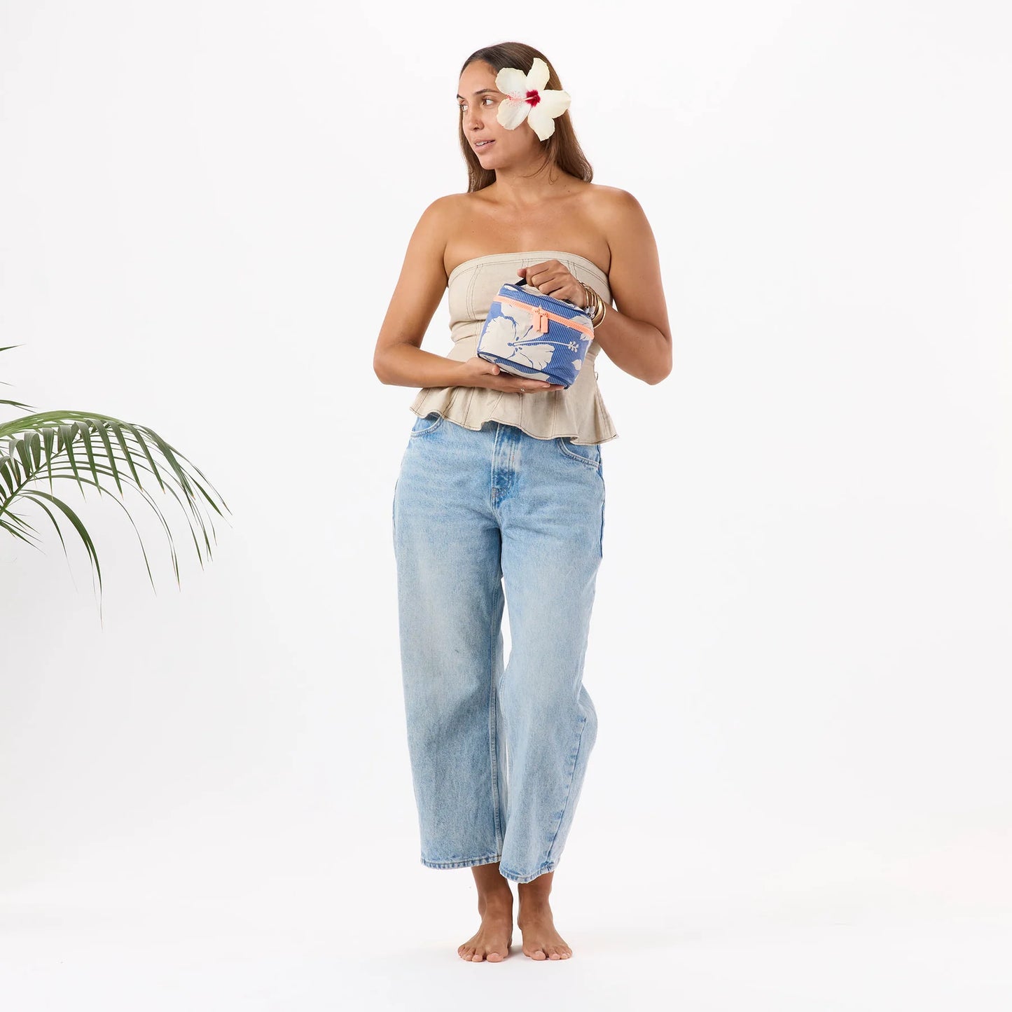 Woman holding a small blue bag with a white background