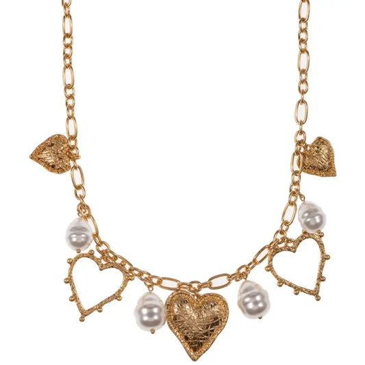 Gold necklace with heart-shaped charms and pearls on a white background