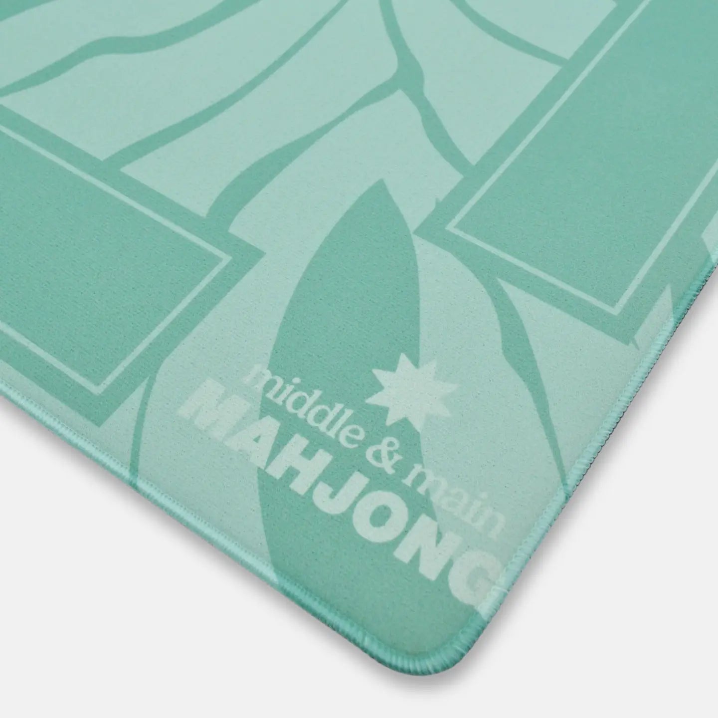 Green Mahjong mat with 'middle & main' branding on a white background
