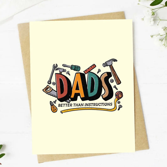 Greeting card with 'DADS BETTER THAN INSTRUCTIONS' text and tool illustrations on a white background.