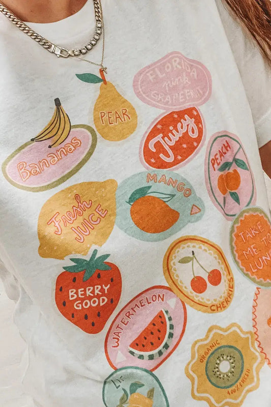 White t-shirt with colorful fruit illustrations and text on a plain background