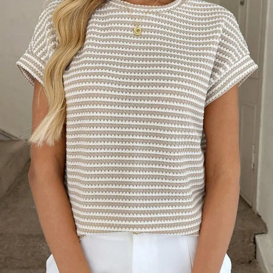 Person wearing a striped shirt with a neutral background