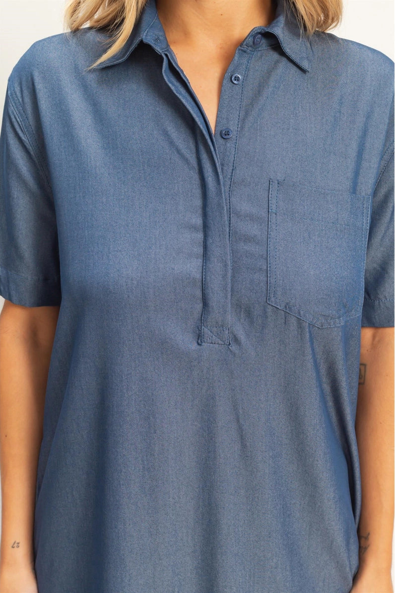 Blue short-sleeve shirt worn by a person on a white background