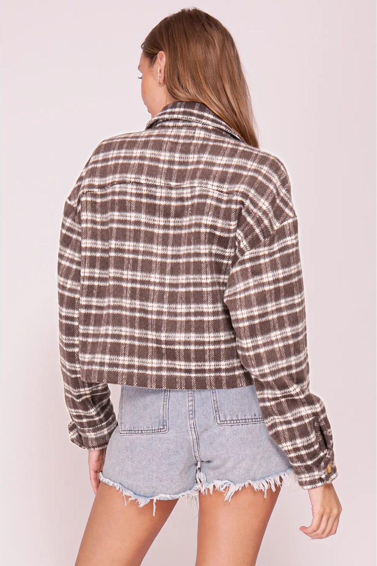 back view of woman in plaid shacket and shorts