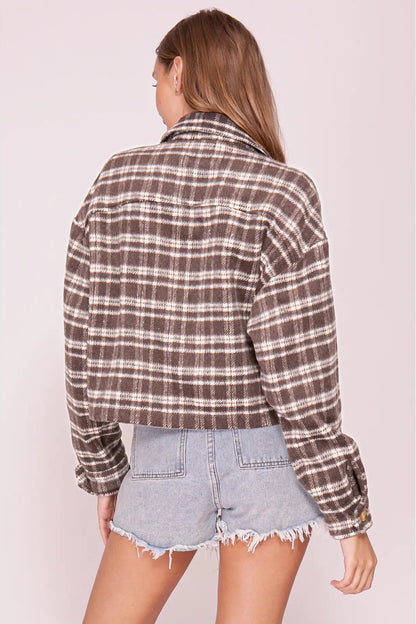 back view of woman in plaid shacket and shorts