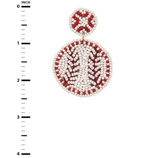 Beaded earrings with red and white pattern on a white background with measurement scale.