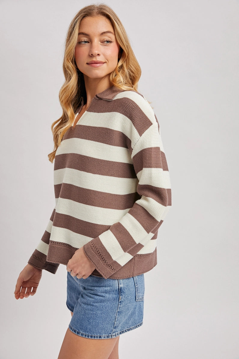 side view of woman in striped sweater and shorts