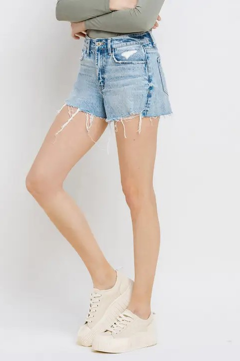Person wearing light blue denim shorts on a white background