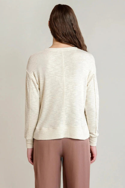 back of woman wearing sweater