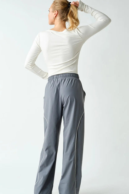 back view of woman in long sleeve tee and pants