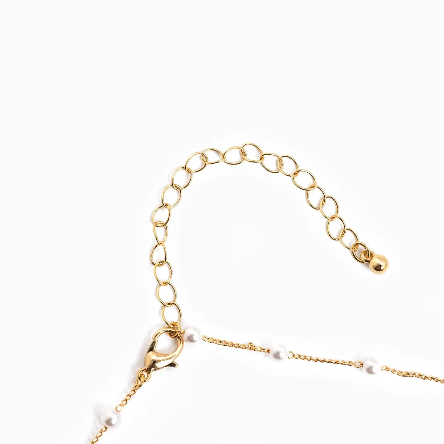 Gold chain necklace with a clasp on a white background