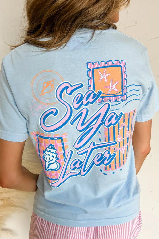 Light blue t-shirt with colorful graphics and text on a neutral background