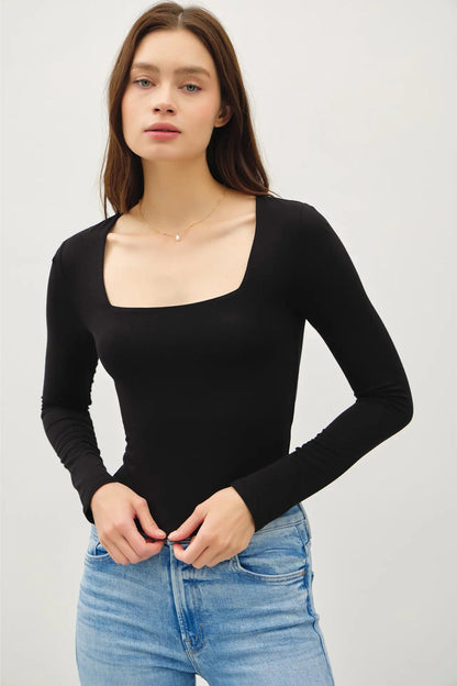 woman wearing square neck long sleeve top with jeans