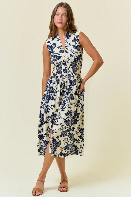 Woman wearing a floral dress on a plain background