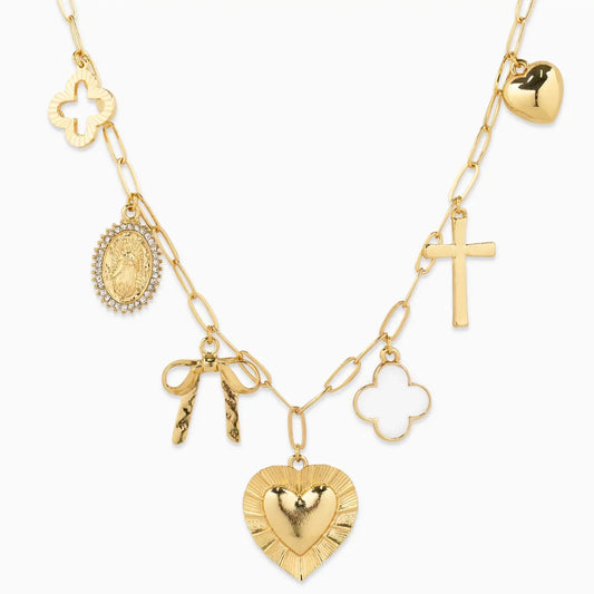 Gold necklace with various charms on a white background