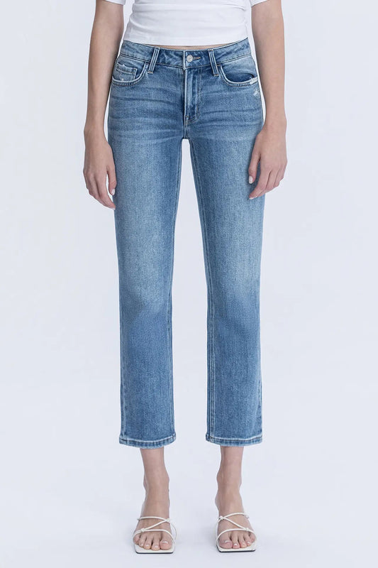 Person wearing light blue jeans on a white background