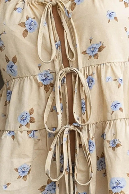 Beige dress with blue floral pattern and tie details